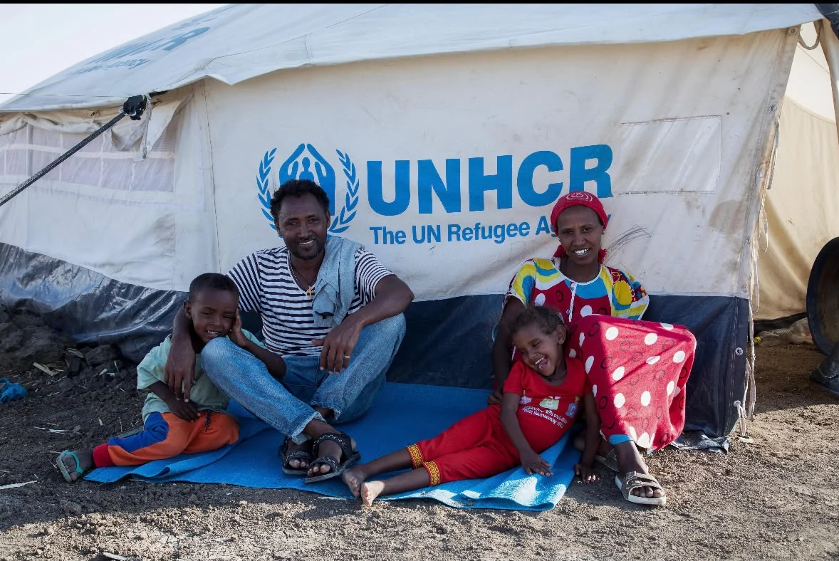 A Burundian woman hugs four of her children